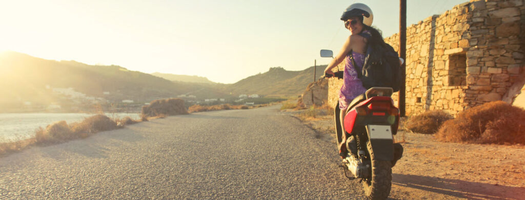 How To Find The Best Travel Insurance - Girl on moped