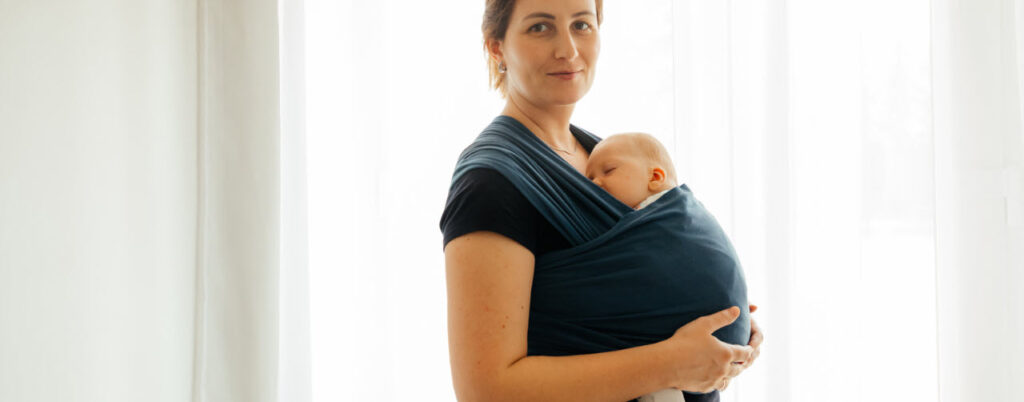 best baby carriers for travel - women with baby in carrier