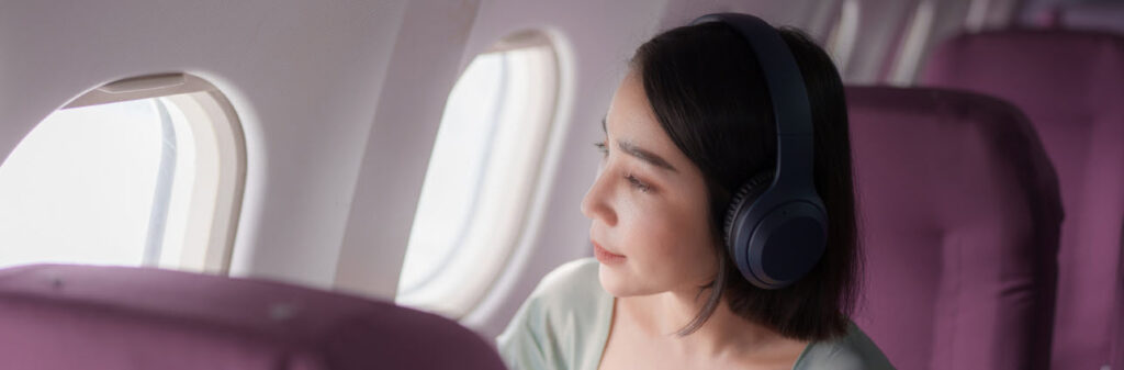 Noise Cancelling Headphones For Flying - girl on plane