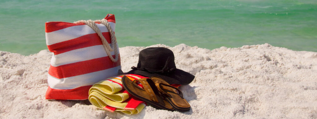 day bags for cruising - bag and towel on beach