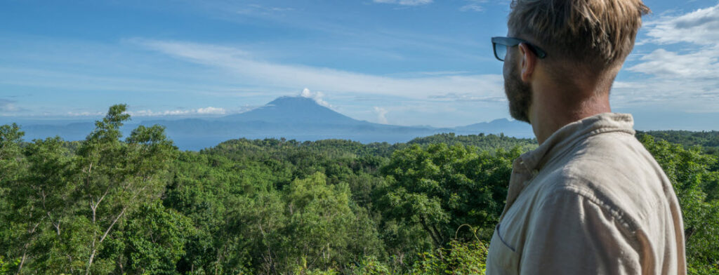 Best hiking trails in bali - man looking at Mt Agung