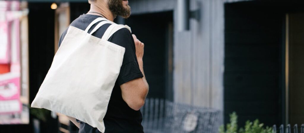 best travel tote bags - man carrying tote bag