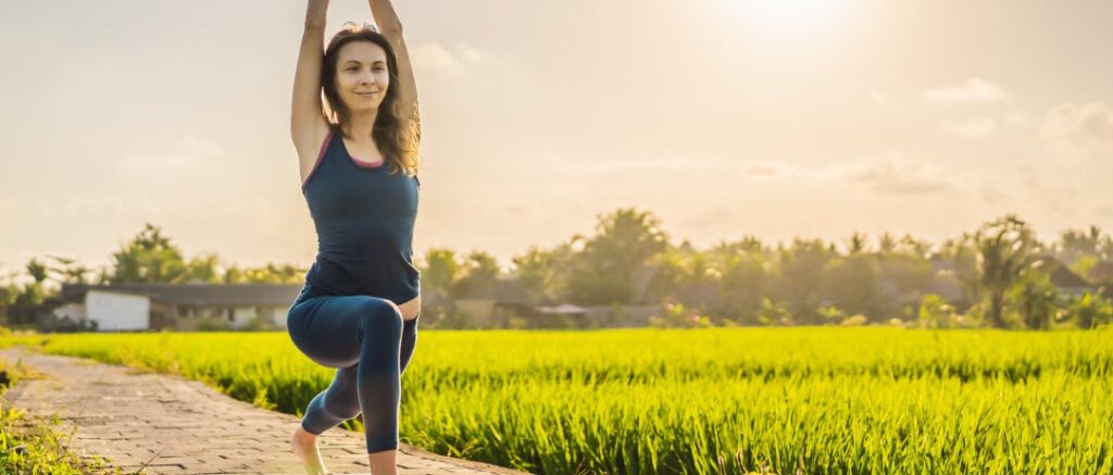 things to do in Canggu - woman doing yoga in rice paddie