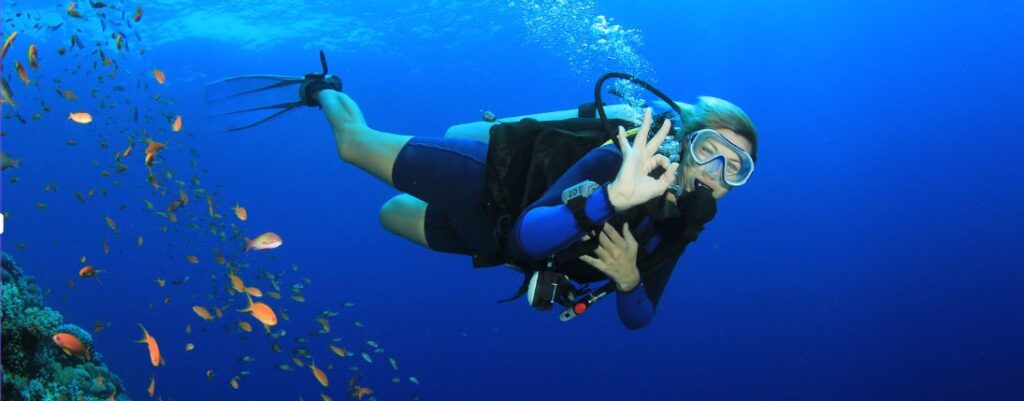 Tips for Flying with Scuba Gear - woman scuba diving