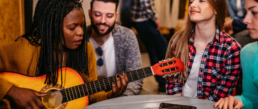 Tips for Staying in a Hostel - Group with Guitar